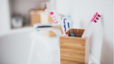 toothbrushes in cup on counter